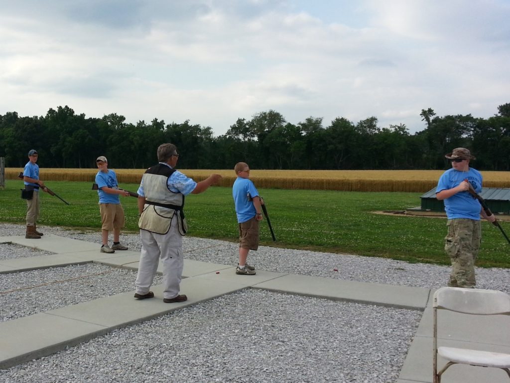 Shooting instructor guiding students on proper technique